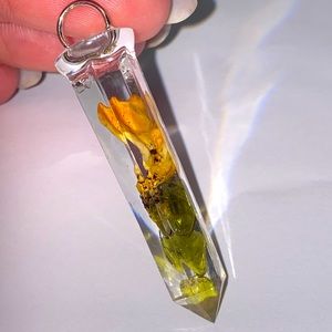 Coral mushroom and tumbled peridot in a clear resin crystal.